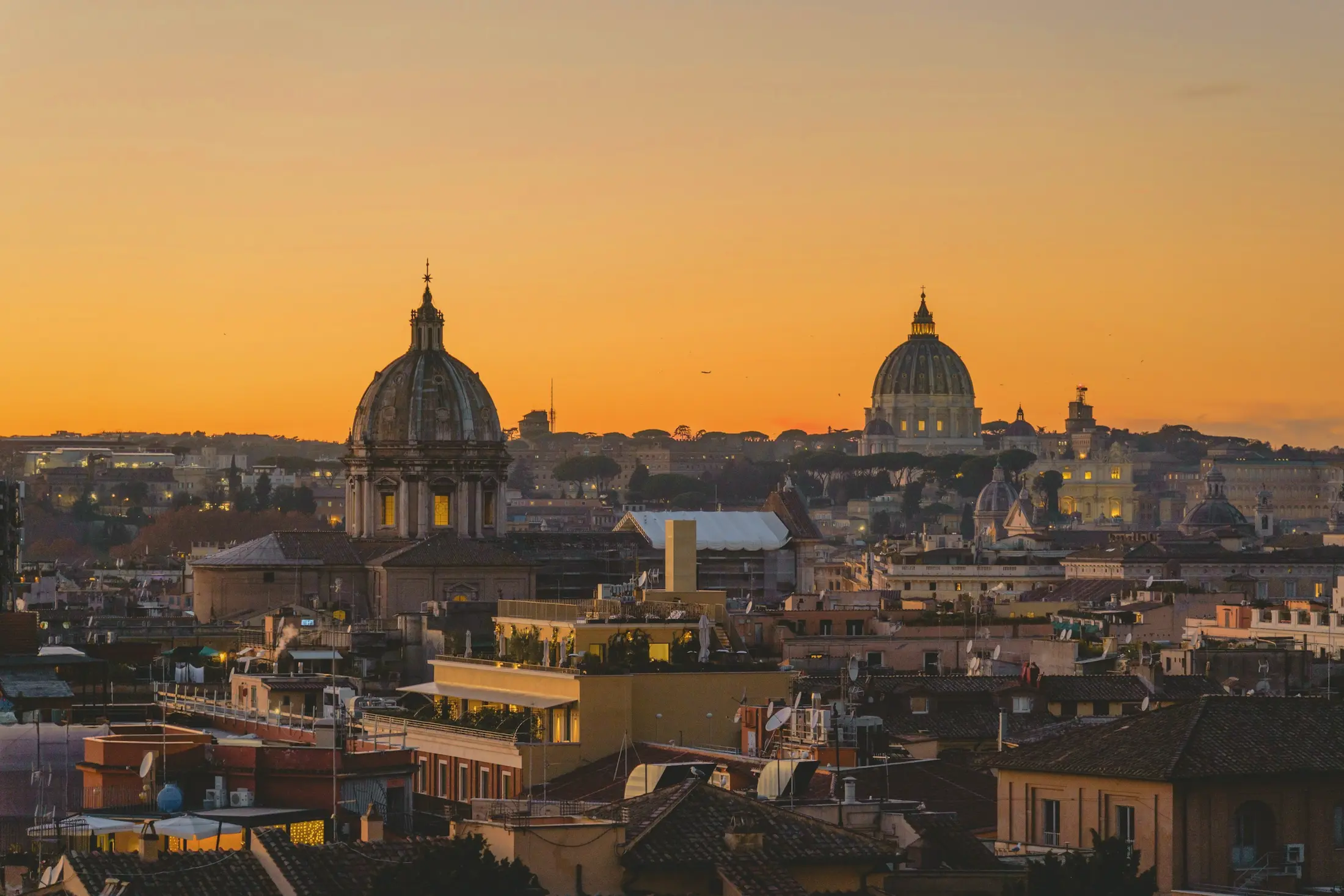 Daken van Rome die gloeien bij zonsondergang.